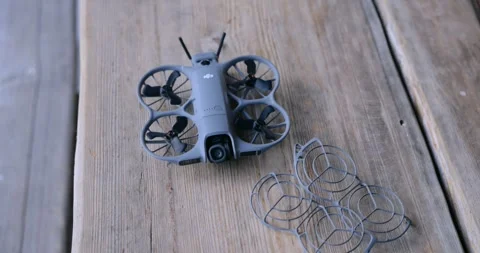 DJI Avata 2 FPV drone on wooden table with propeller guards Stock Footage 333485273