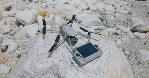 DJI drone and smart controller on rock. Close-up Stock Footage 321209833