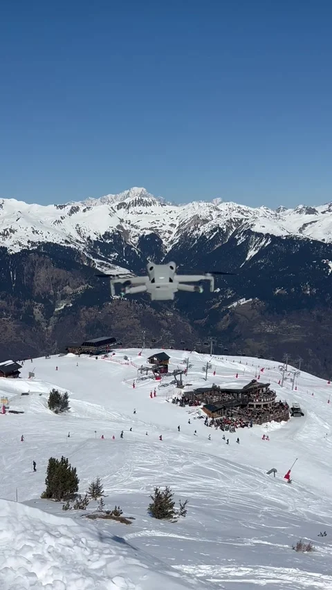 Dji drone flying over the ski slopes of Courchevel resort. Stock Footage 334439672