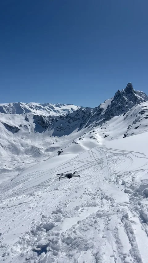 Dji drone flying by winter over snowy mountains Stock Footage 334440878