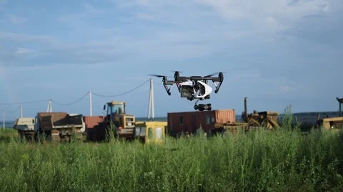 DJI Inspire 1 PRO drone flyes near ground's surface Stock Footage 100018459