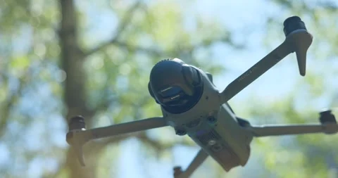 DJI Mavic 4 Pro drone hovering in mid-air. Close up Stock Footage 336775512