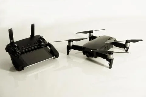 DJI Mavic Air drone with controller and smartphone on white background Stock Photos