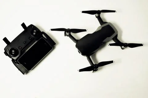 DJI Mavic Air drone with controller and smartphone on white background Stock Photos