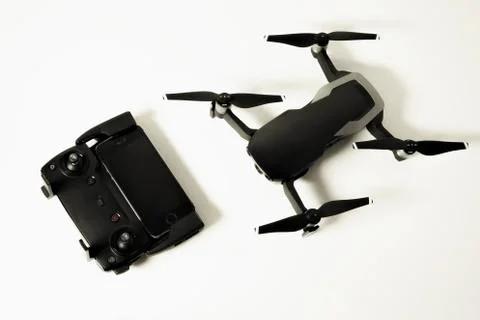 DJI Mavic Air drone with controller and smartphone on white background Stock Photos