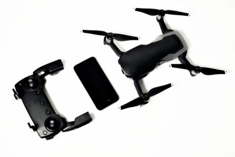 DJI Mavic Air drone with controller and smartphone on white background Stock Photos