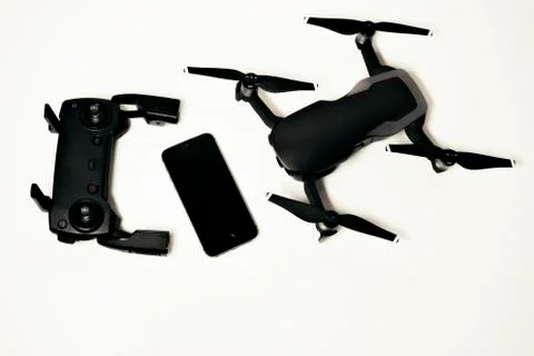 DJI Mavic Air drone with controller and smartphone on white background Stock Photos