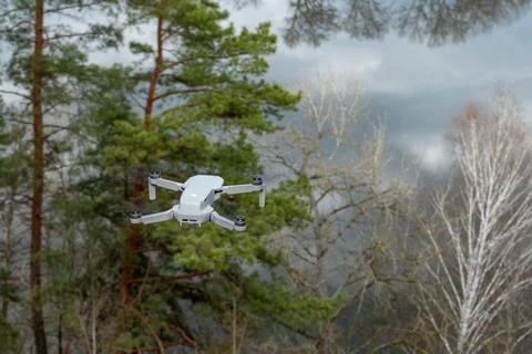 Dji Mavic Mini 2 drone fly in forest near river Stock Photos