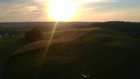 DJI Mavic Pro drone appearing from below during sunset over fields Video stock 94827081