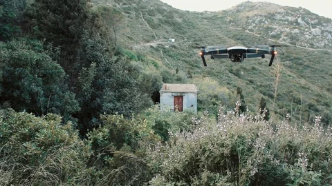 DJI Mavic Pro drone flying over small old Greek house Stockbeeldmateriaal 97817108