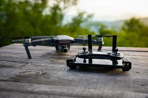 DJI Mavic pro drone with a mobile phone plugged to a controller on a wooden t Stock Photos