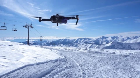 DJI Mavic pro flight in winter, view from the back. Snowy mountains. Stock Footage 125791617
