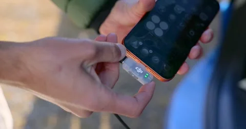 DJI Mic 2 Connected To A Mobile Phone. Close-up Shot Stock Footage 325257544