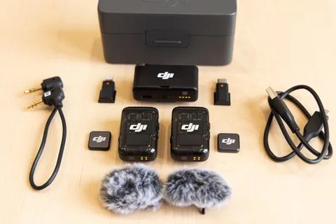 DJI MIC 2 microphone kit with accessories on wooden surface Stock Photos