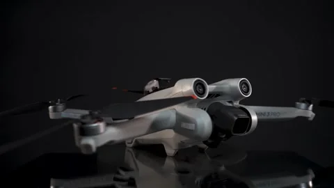 DJI Mini 3 Pro - Unfolded - Spinning Side-On - Focus Rack - Black Background 動画素材 255208273