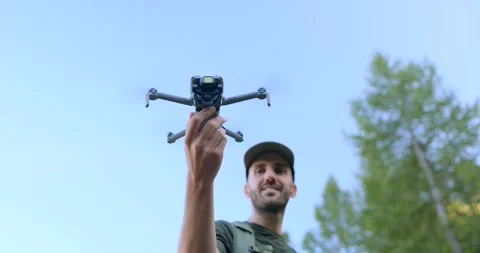 DJI Mini 5 Pro drone take-off from hand of pilot man. Copy space Stock Footage 341437853