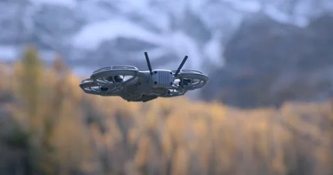 Dji Neo 2 Drone Hovering Over Autumn Landscape Stock Footage 336774766