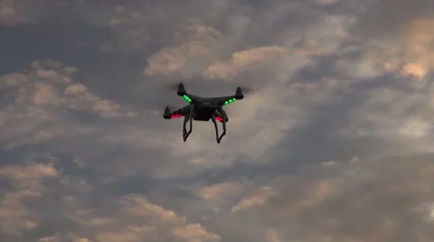 A DJI Phantom 2 quadcopter drone hovers at dawn Stock Footage 45432321