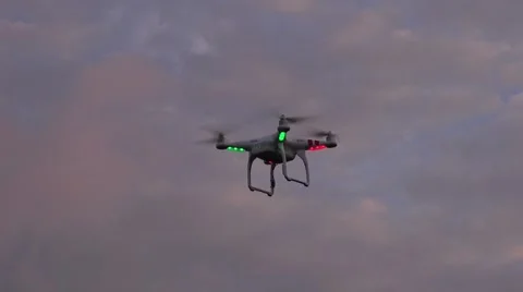 A DJI Phantom 2 quadcopter drone hovers at dusk Stock Footage 45432335