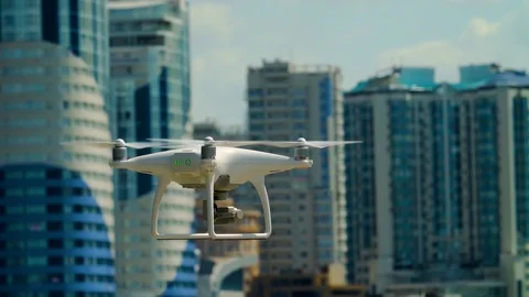 Dji Phantom 4 in the frame. Quadcopter on the background of houses. Vídeos de archivo 91996094