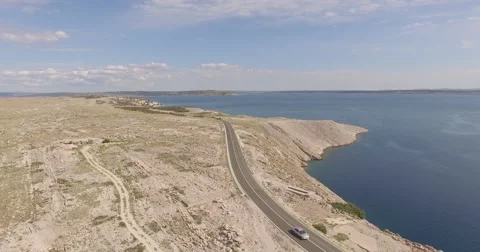 Dji phantom 4 k drone flying on a beach above road on a mountain at summer Stock Footage 54196656