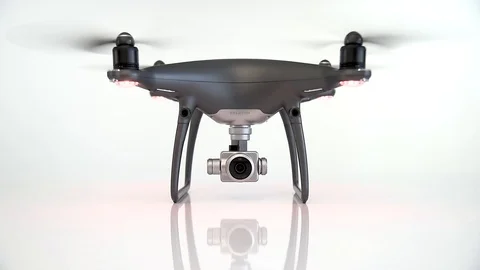 DJI Phantom 4 Pro Obsidian Edition with working propellers on white background. Stock Footage 105603903