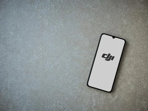 DJI Store app launch screen on smartphone on ceramic stone background Stock Photos