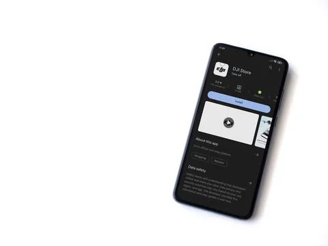 DJI Store app play store page on smartphone on white background Stock Photos
