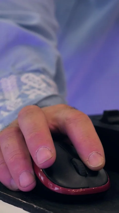 DJ's hand holding a computer mouse next to a digital mixing controller desk Stock Footage 344074844