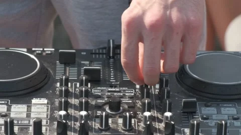 DJ's hands adjusting the sound levels of the music mixer. Stock Footage 146464665