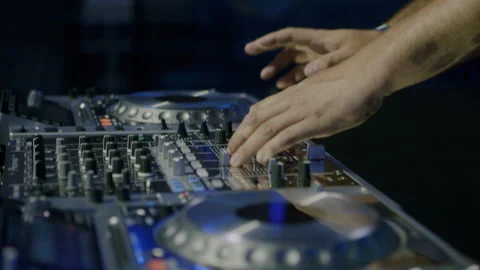 DJ's hands on a console playing at a concert or music festival. 4K Stock Footage 221554384