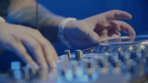 DJ's hands on a console playing at a concert or music festival. 4K Stock Footage 221555198