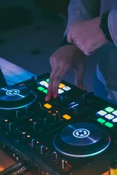 The DJ's hands control the music console. DJ's remote control close-up Stock Photos