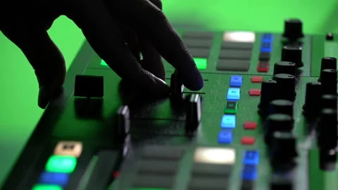 Dj's hands on the mixing console. fingers move the handle on the remote. Green Stock Footage 145095081