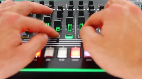 DJ's hands press buttons and pull sliders on the control panel Video stock 241566116