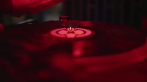 The DJ's hands put a black vinyl record on the DJ player. Black vinyl background Stock Footage 147529706