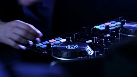 DJ's Hands While He Uses DJ Mixer and a Laptop Stock Footage 71812141