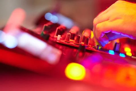 DJ's hands on a working music console Stock Photos