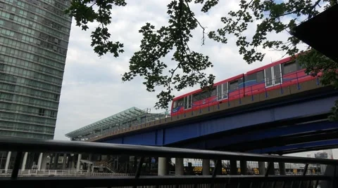 DLR Docklands Light Railway pulling into canary wharf station Stock Footage 66582442