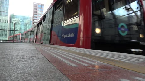 DLR Docklands Light Railway train pulling into Canary Wharf station Stock Footage 66582786