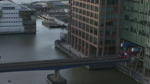 DLR train passing right to left mid shot at Canary Wharf train station at dusk  Stock Footage 74258865
