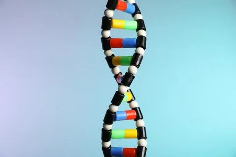 DNA structure model on color background, closeup Stock Photos