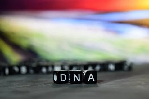 DNA on wooden blocks. Cross processed image with bokeh background Stock Photos