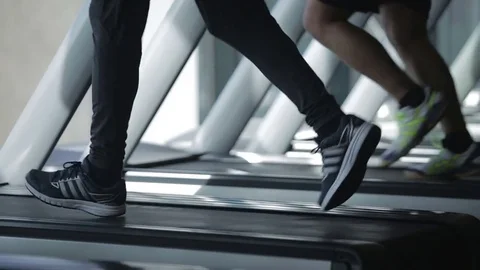 Dnipro March 2017. Young athletic man and woman running on treadmill in gym.  Stock Footage 81207054