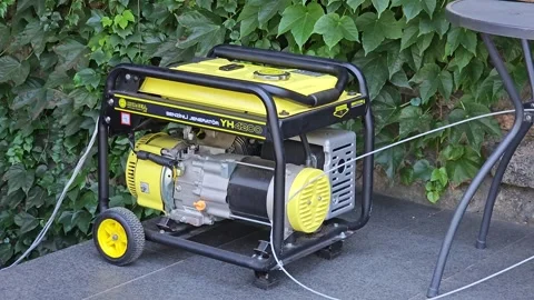 Dnipro, Ukraine - July 4, 2024: Yellow portable gasoline generator used for back Stock Footage 341829006