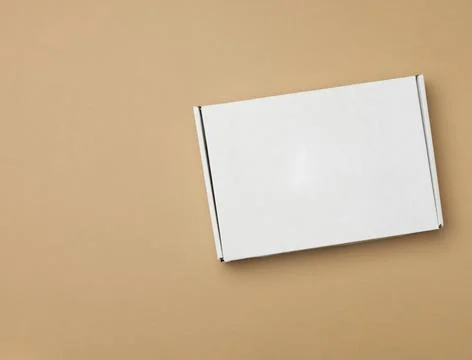 DNN 8585white paper rectangular box on beige background, top view Stock Photos