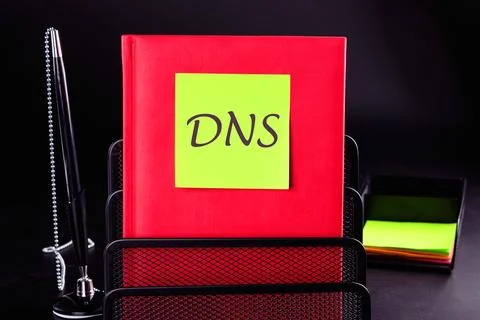 DNS Domain Name Server on a sticker on a red notebook on a black background Stock Photos