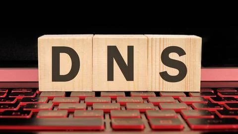 DNS -Domain Name Server written on wooden cubes on the laptop keyboard Stock Photos