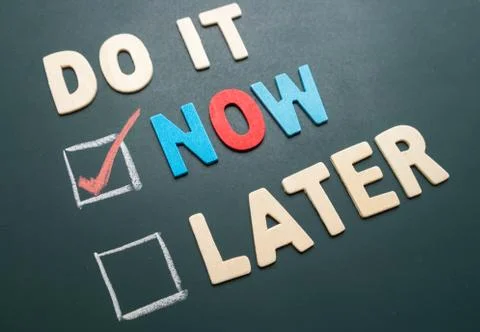 Do It Now or Later with checkbox and red check on blackboard Stock Photos