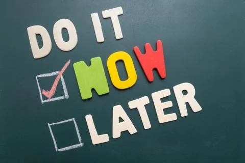 Do It Now or Later with checkbox and red check on blackboard Stock Photos